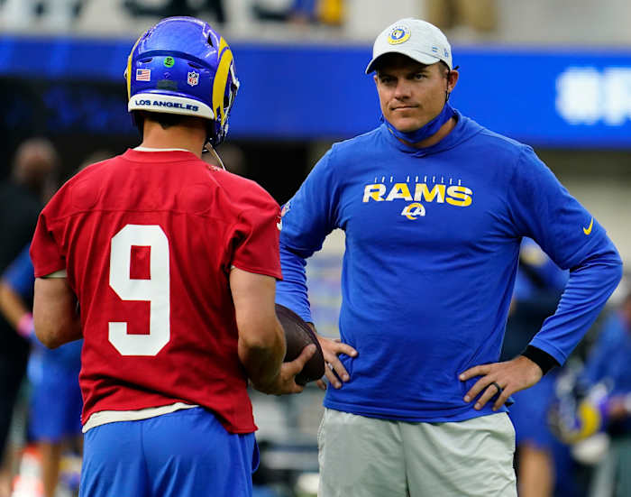 Los Angeles Rams quarterback Matthew Stafford (9) talks to offensive coordinator Kevin O'Connell during an offseason workout at SoFi Stadium.